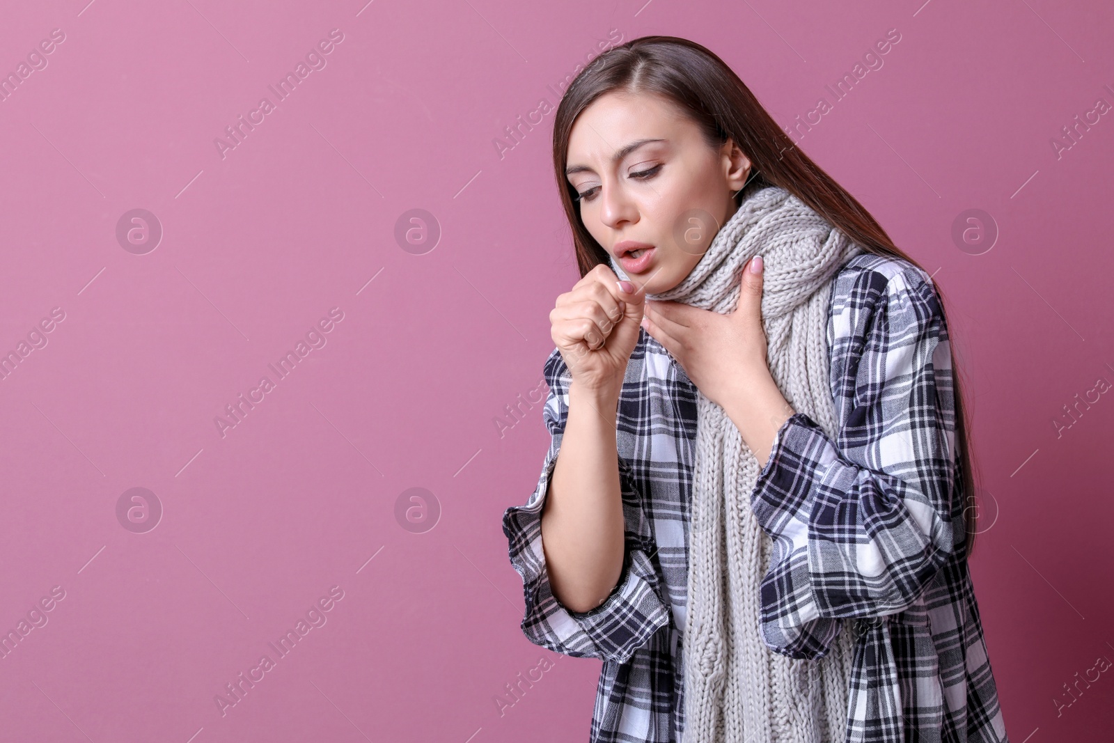 Photo of Young woman coughing on color background