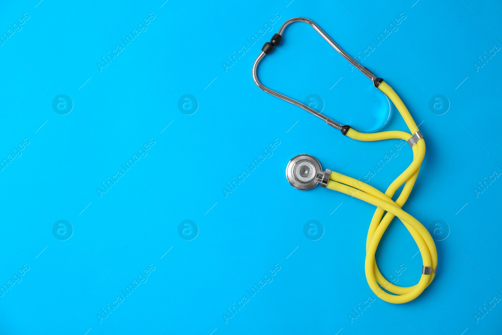 Photo of Stethoscope on color background, top view. Medical equipment