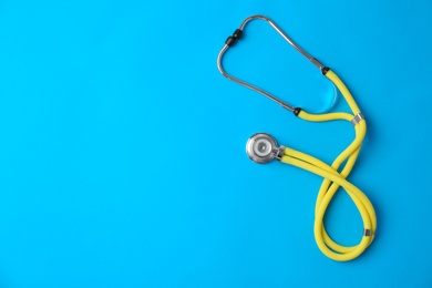 Stethoscope on color background, top view. Medical equipment