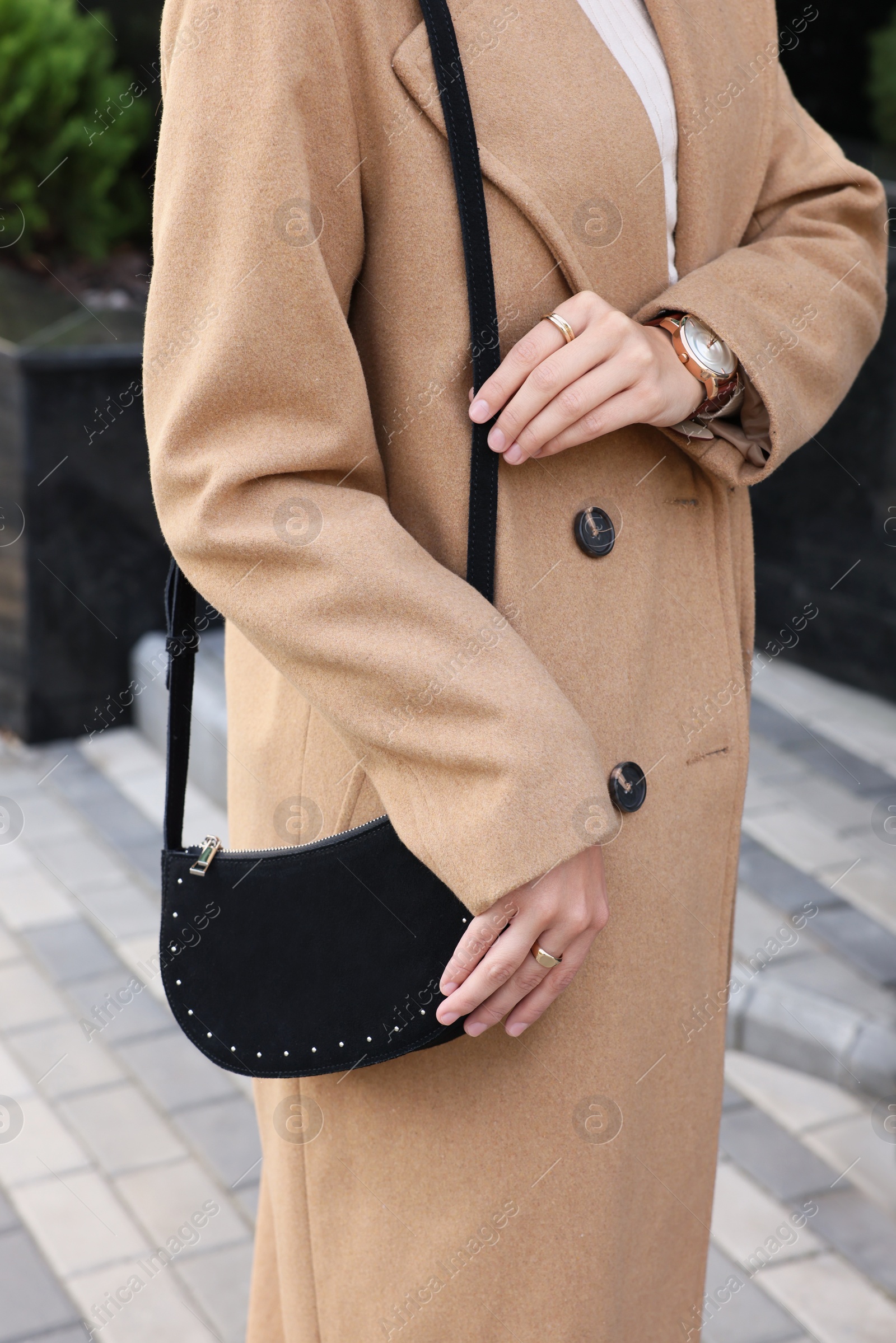 Photo of Fashionable woman with stylish bag on city street, closeup