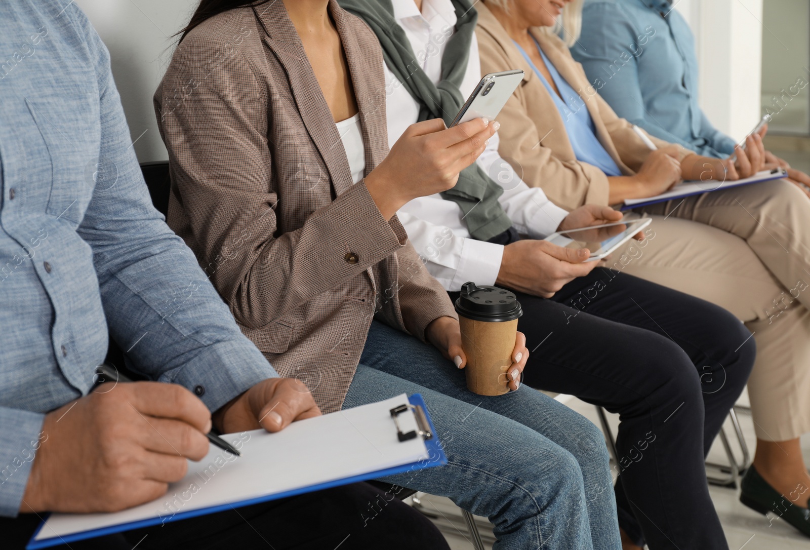 Photo of People waiting for job interview in office, closeup