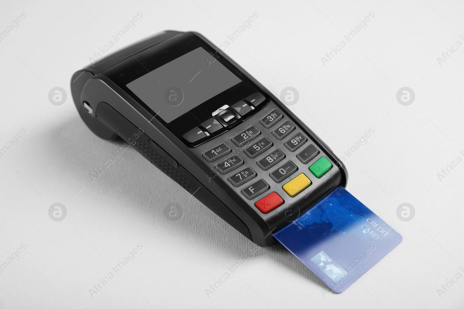 Photo of Modern payment terminal with credit card on grey background