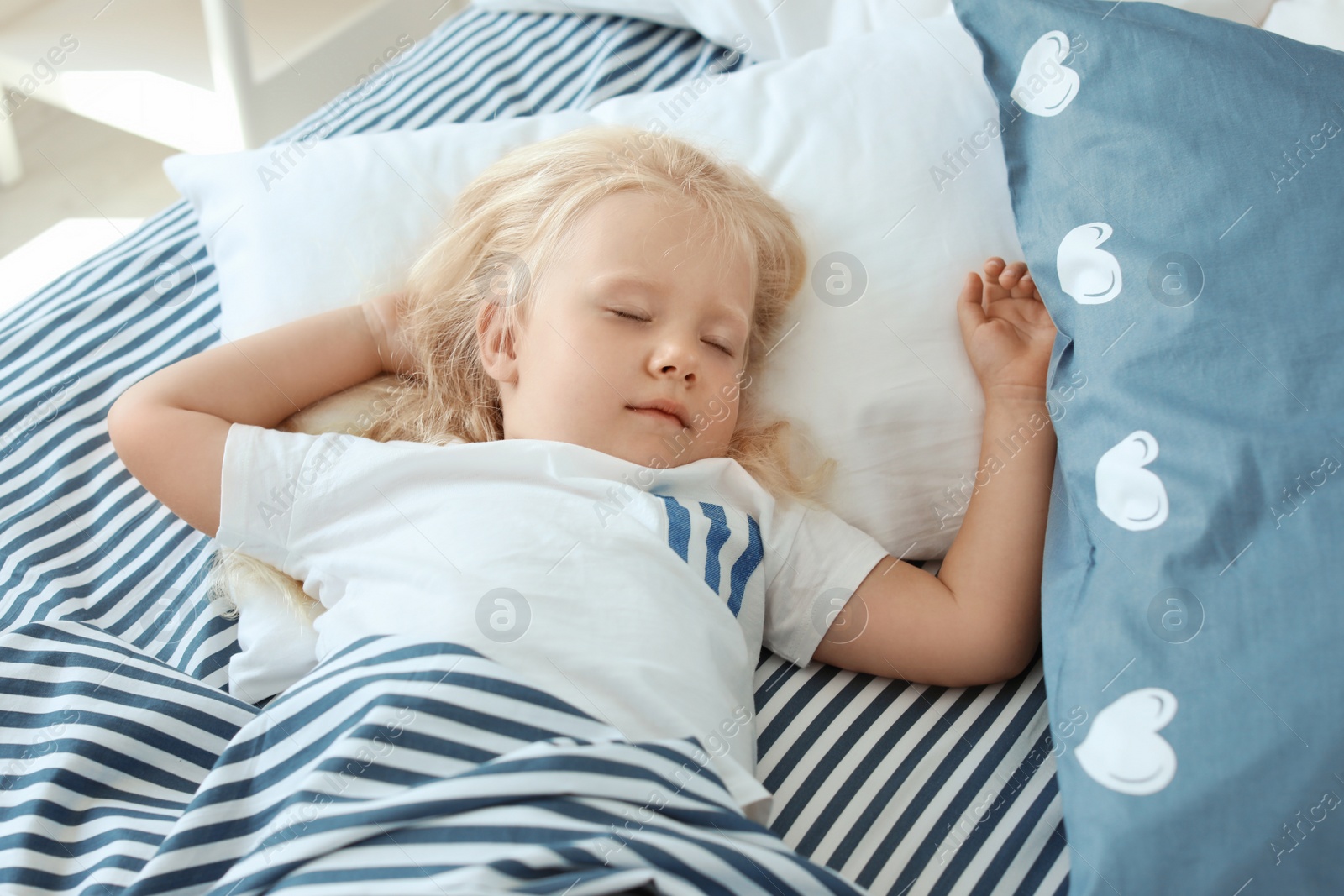 Photo of Cute little girl sleeping in bed at home