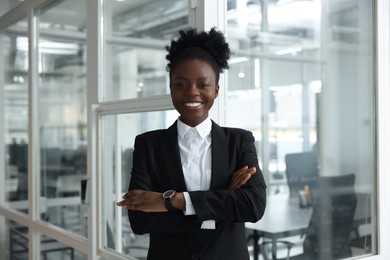 Happy woman with crossed arms in office. Lawyer, businesswoman, accountant or manager