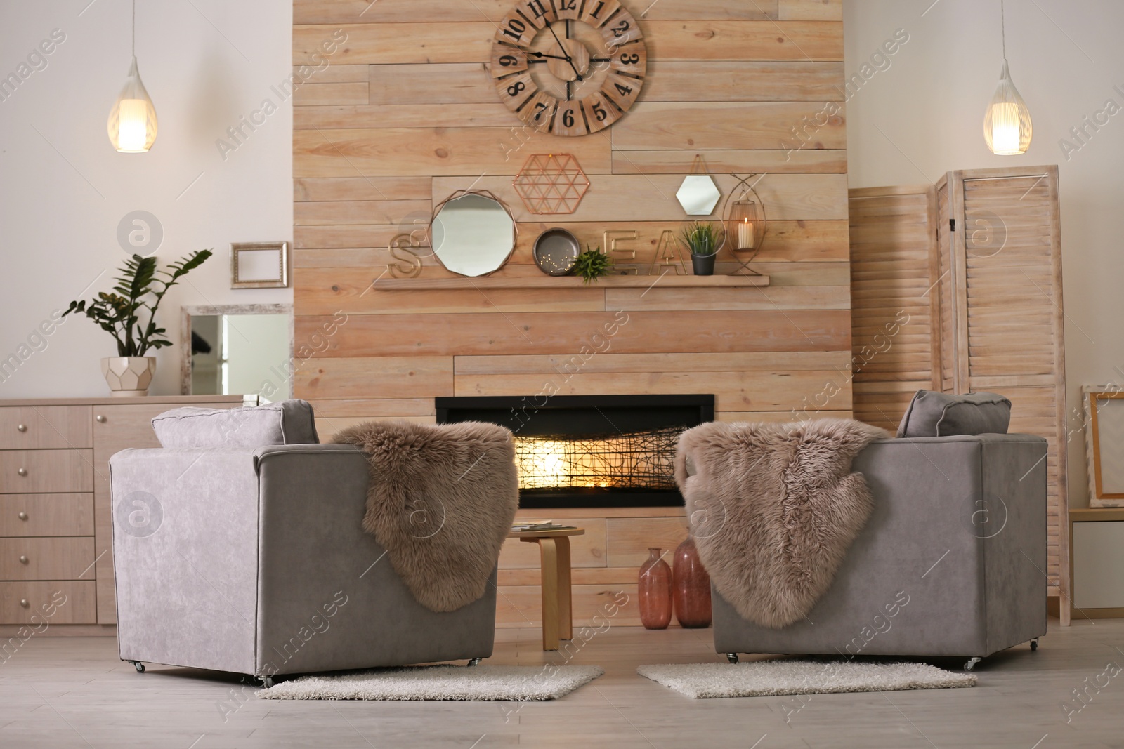 Photo of Cozy living room interior with comfortable armchairs and decorative fireplace