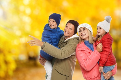Happy family spending time together at autumn park 