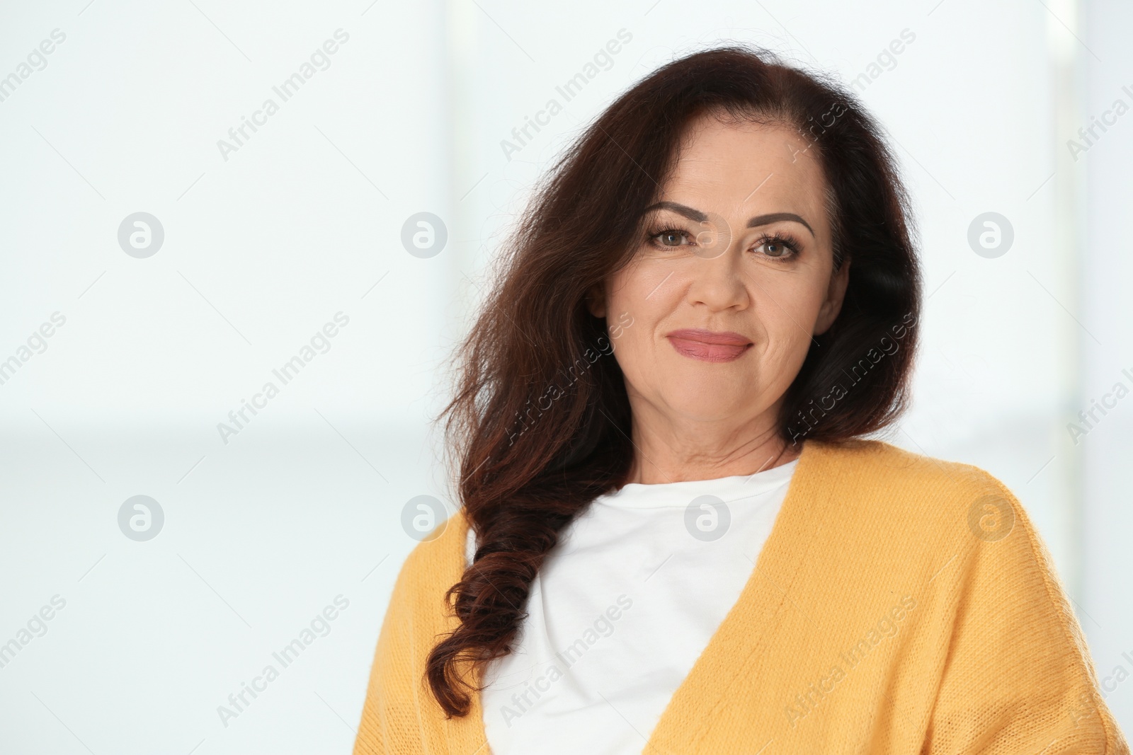 Photo of Portrait of beautiful older woman against light background with space for text