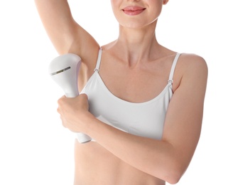 Young woman doing armpit epilation procedure on white background, closeup