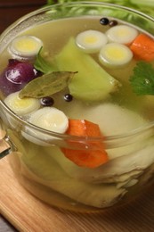 Photo of Glass pot with tasty bouillon on table, closeup