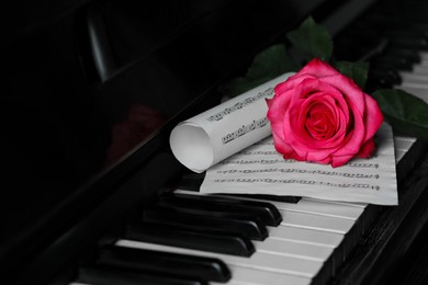 Beautiful pink rose and musical notes on piano keys