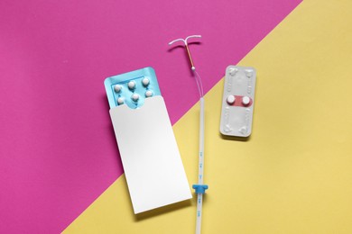 Contraception pills and intrauterine device on color background, flat lay. Choosing birth control method