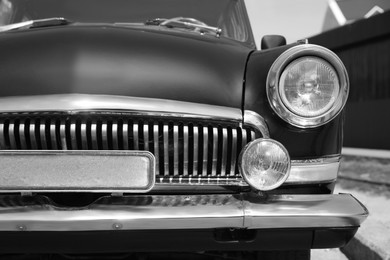 Image of Beautiful retro car on street, closeup. Black and white effect