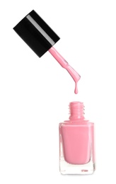 Photo of Brush over nail polish bottle on white background