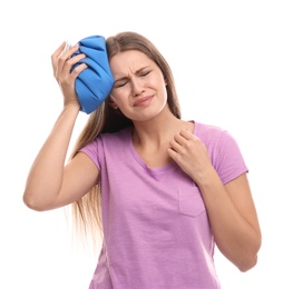 Unhappy woman using cold pack to cure headache on white background