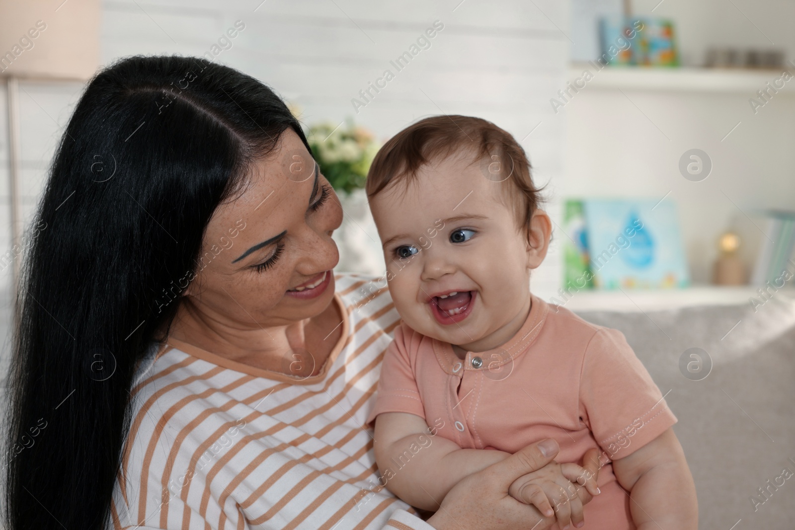 Photo of Happy mother with her cute baby at home