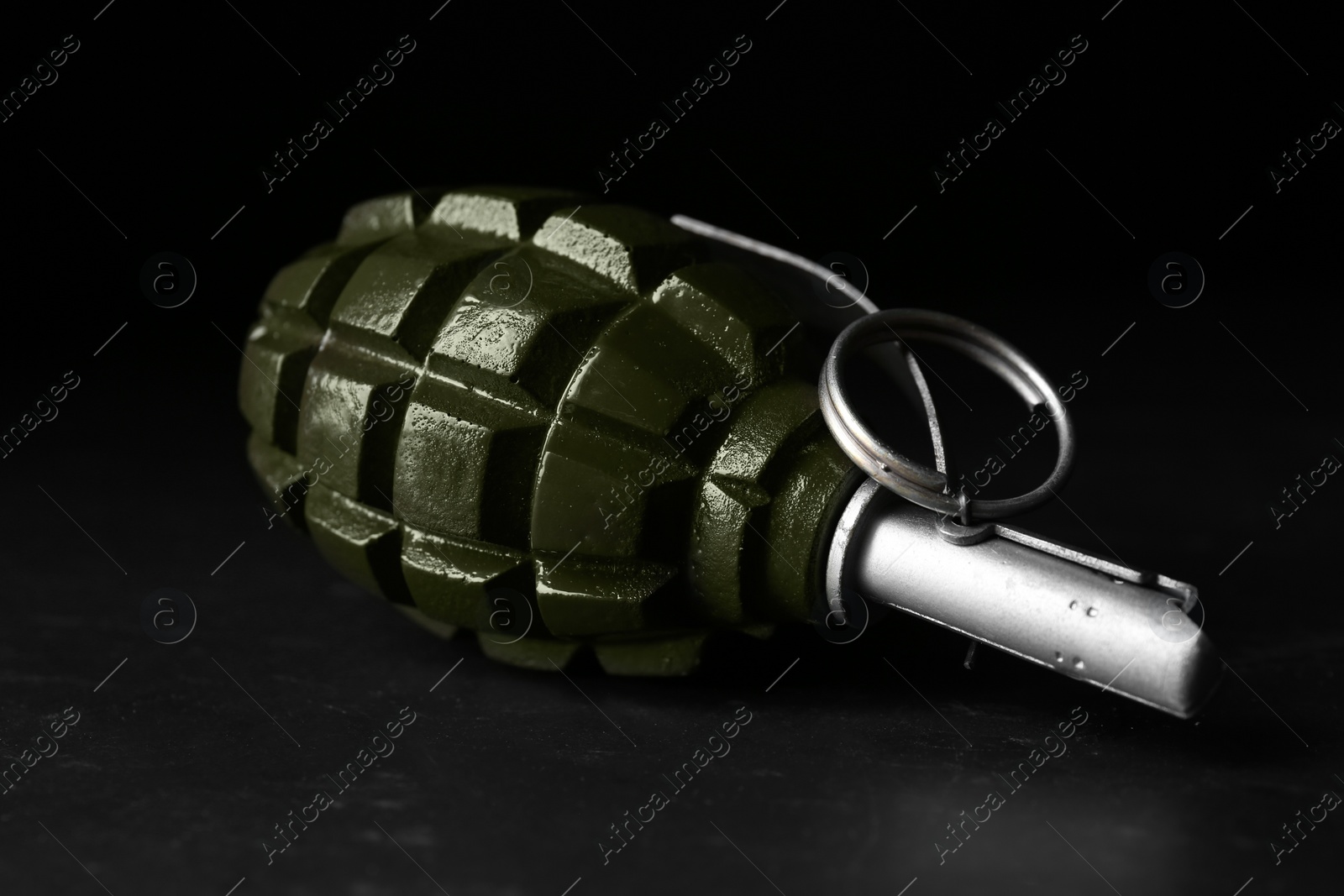 Photo of Hand grenade on black background, closeup. Explosive weapon