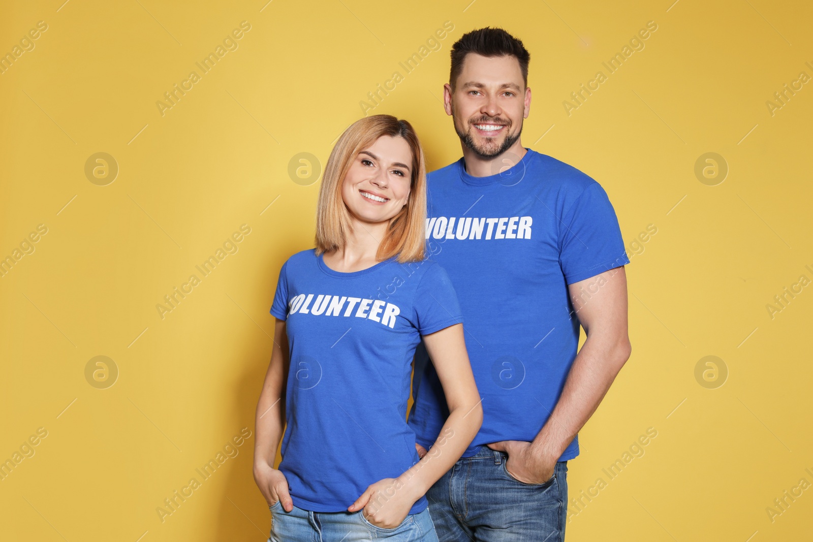 Photo of Portrait of volunteers in uniform on yellow background