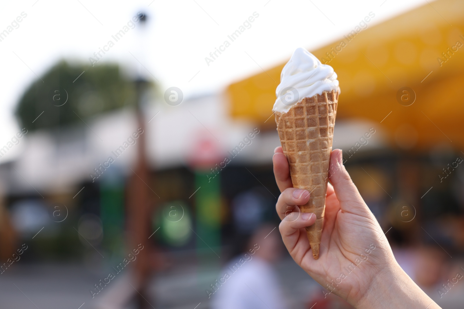 Photo of Lviv, Ukraine - September 26, 2023: Woman with McDonald's ice cream outdoors, closeup. Space for text