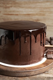 Photo of Freshly made delicious chocolate cake on wooden table