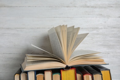 Stack of hardcover books on white wooden background