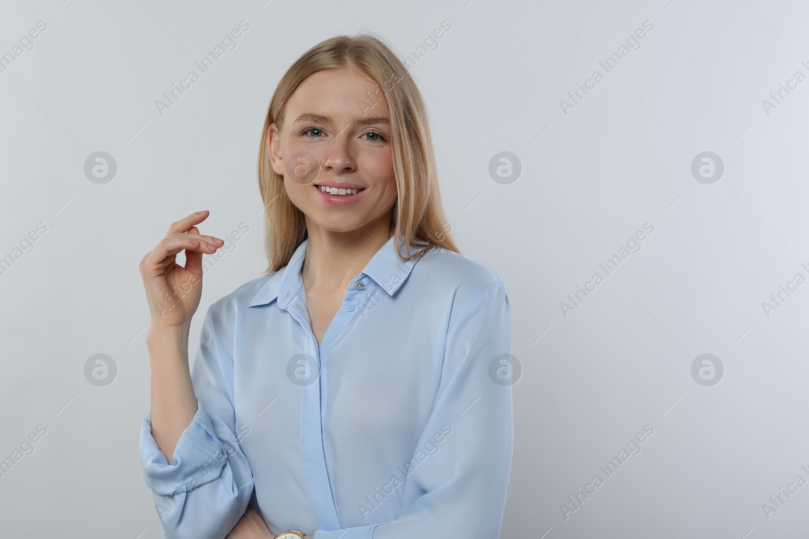 Photo of Portrait of beautiful young woman in stylish blouse on white background. Space for text