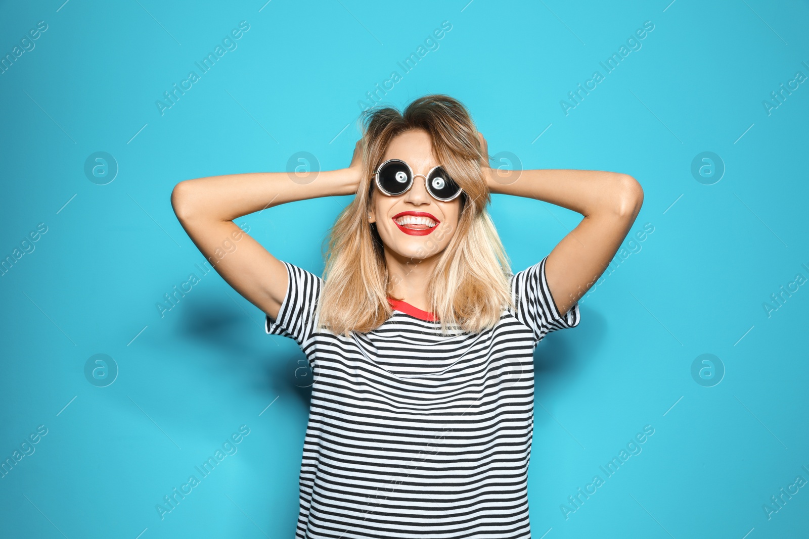 Photo of Beautiful young woman with healthy long blonde hair on color background