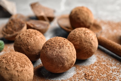 Photo of Delicious raw chocolate truffles on grey background