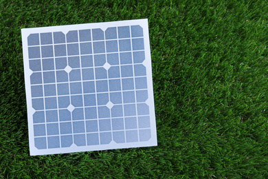 Photo of Solar panel on green grass. Space for text