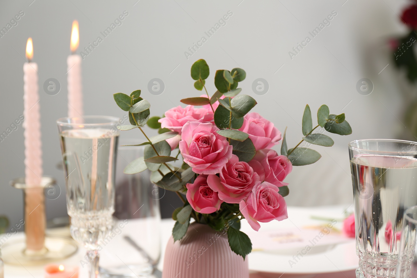 Photo of Romantic dinner. Bouquet with beautiful pink roses on table