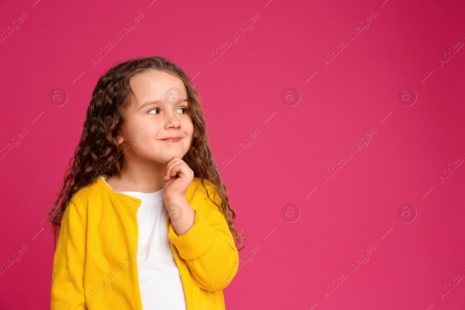 Photo of Portrait of cute little girl on pink background. Space for text