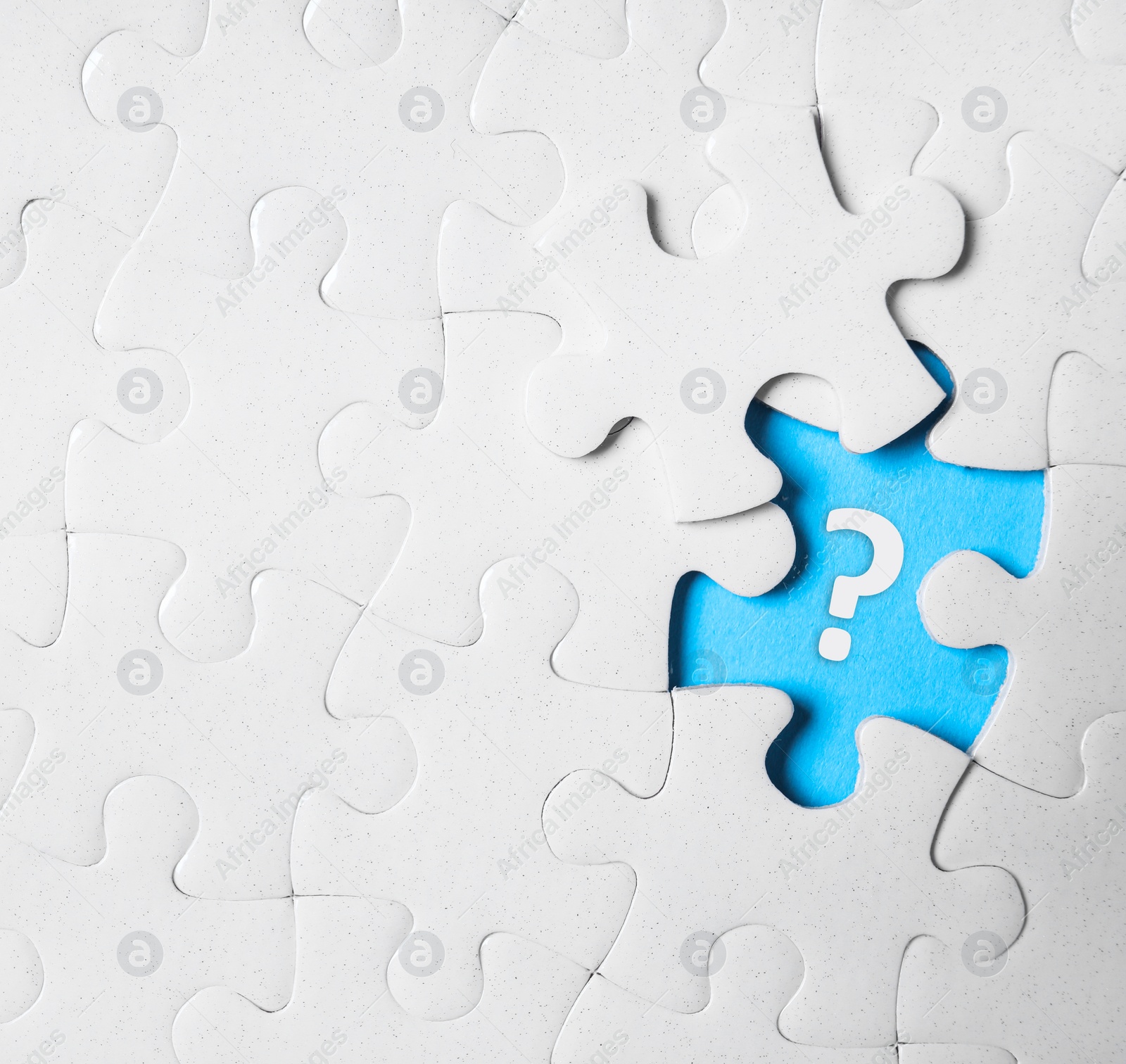 Image of White puzzle with missing piece and question mark on white background, top view