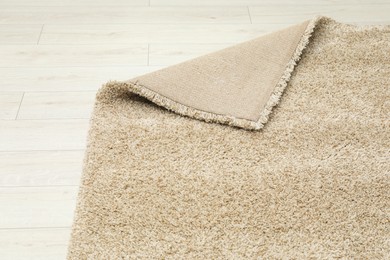 Photo of Soft beige carpet on white laminated floor indoors