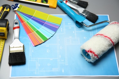 Photo of Set of decorator's tools and project drawing on table