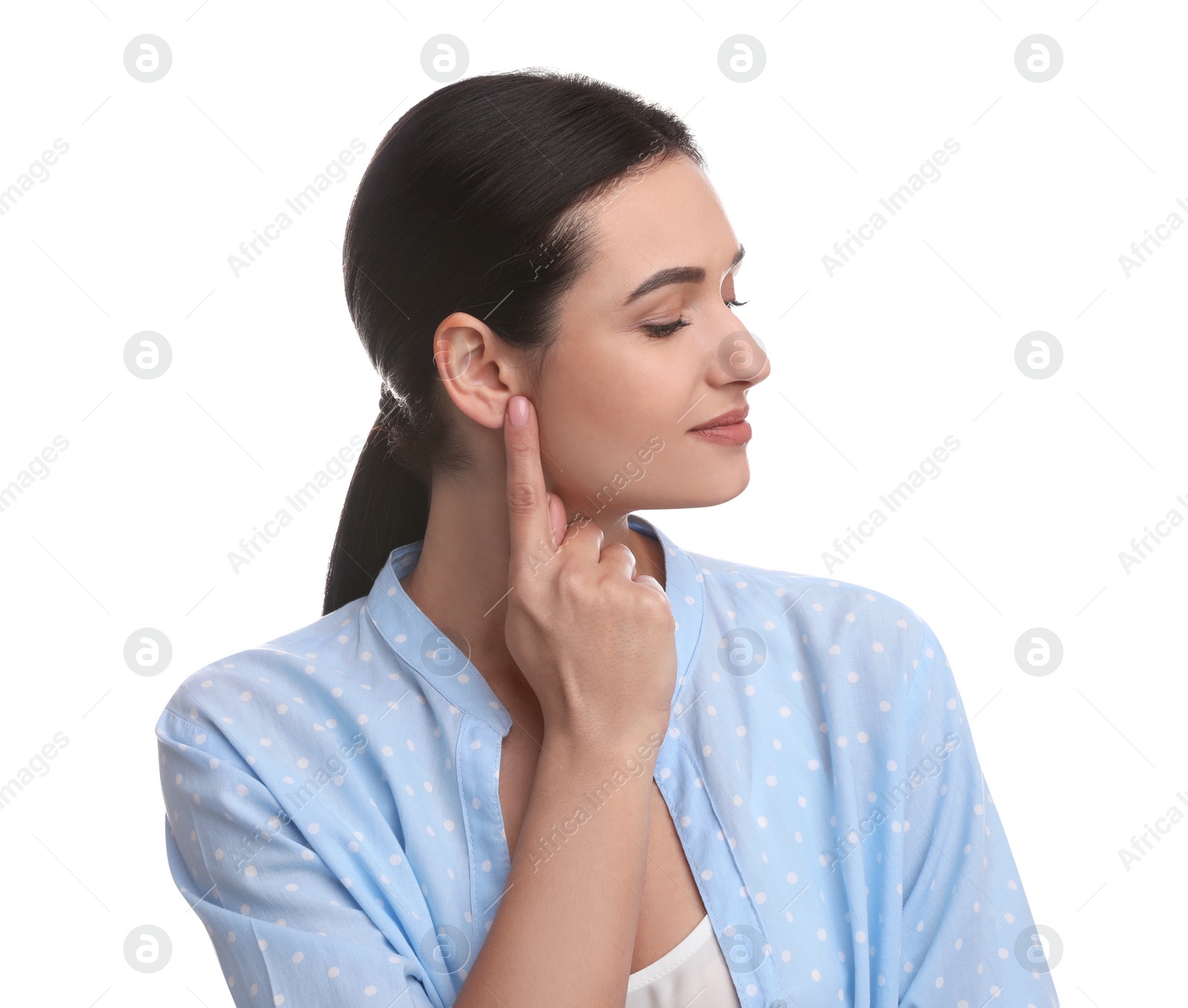 Photo of Young woman pointing at her ear on white background