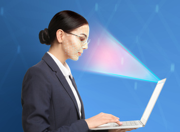 Facial recognition system. Woman using laptop on blue background 