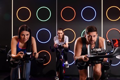 Photo of Group of people training on exercise bikes in fitness club