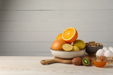 Allergenic food. Different fresh products on light wooden table, space for text