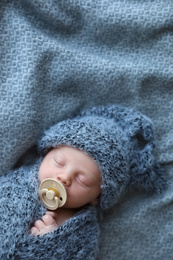 Photo of Cute newborn baby sleeping on blanket, top view. Space for text