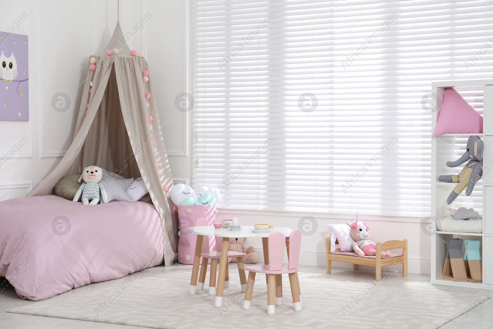 Photo of Cute child's room interior with toys and modern furniture