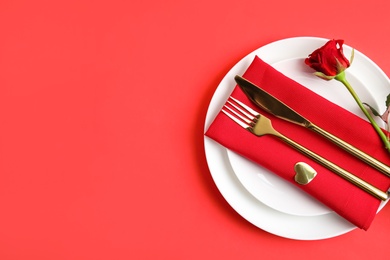 Romantic table setting on red background, top view with space for text. Valentine's day celebration