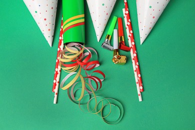 Photo of Many different party items on green background, flat lay