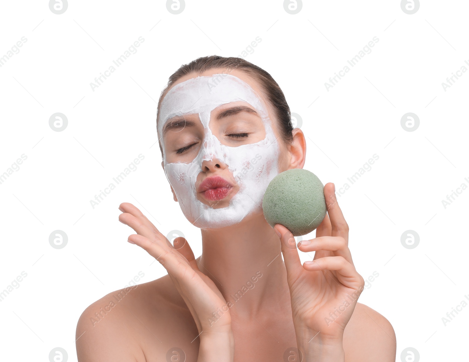 Photo of Happy young woman with face mask and sponge on white background