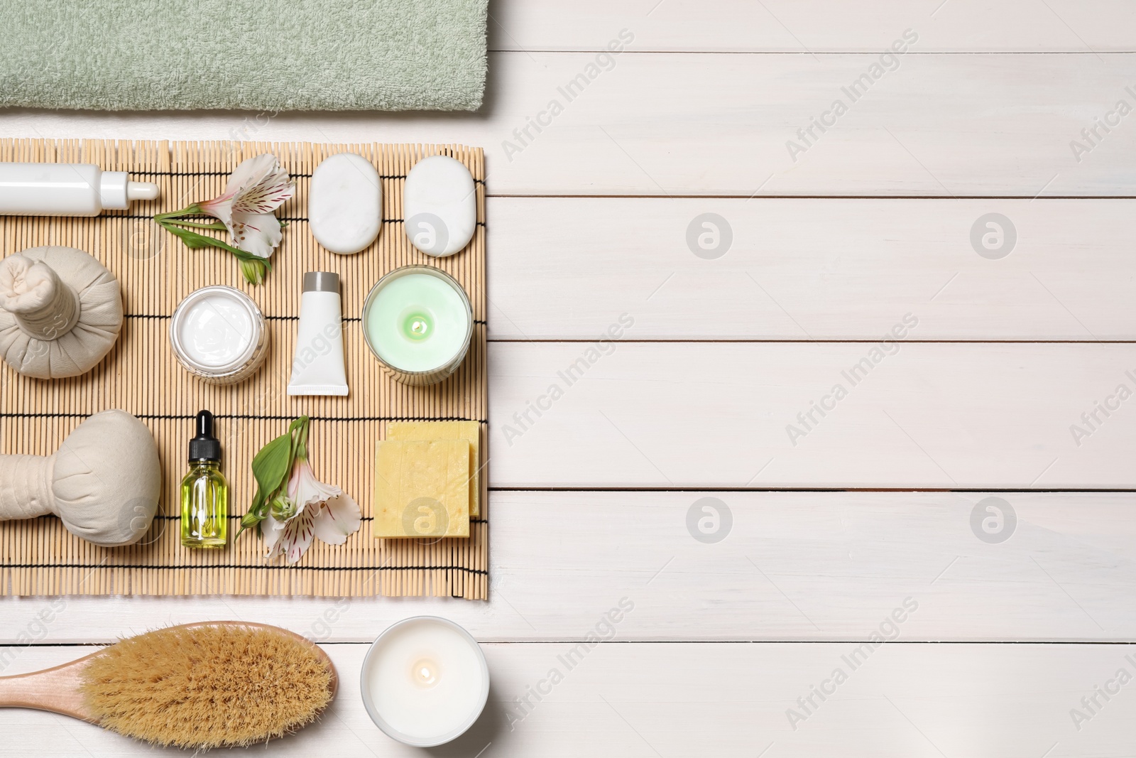 Photo of Flat lay composition with spa essentials on white wooden background. Space for text