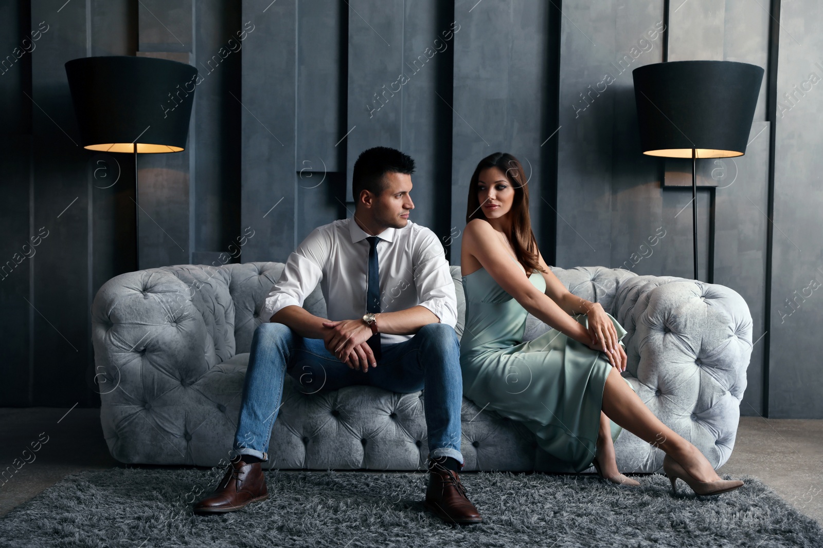 Photo of Beautiful couple in stylish living room. Luxury lifestyle