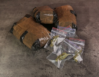 Photo of Hemp in packages on grey table. Drug addiction