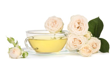 Photo of Aromatic herbal tea in glass cup and roses isolated on white