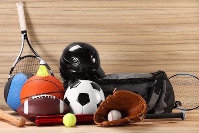 Photo of Many different sports equipment on wooden table