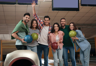 Photo of Group of friends with balls in bowling club