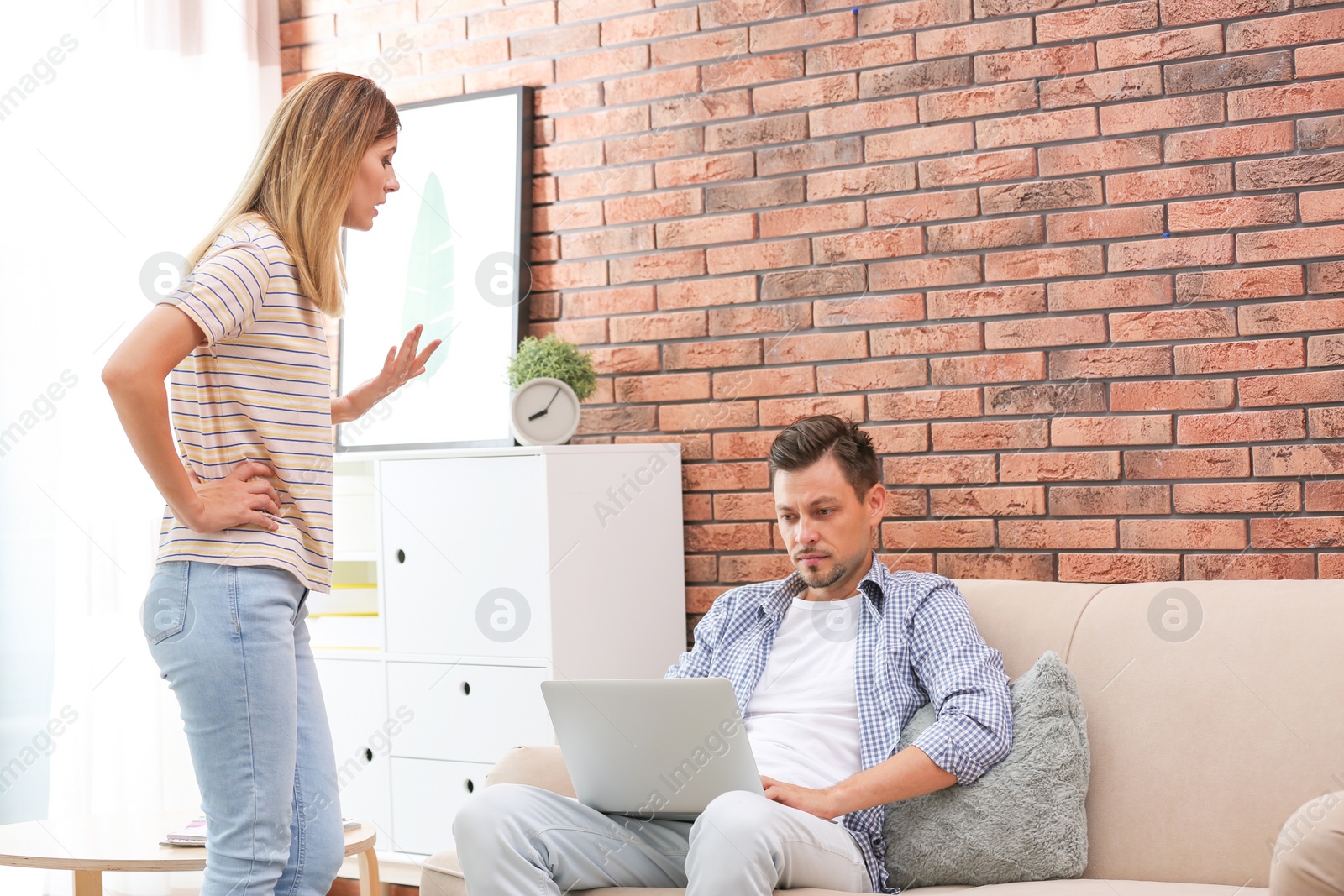 Photo of Lazy husband quarrelling with hardworking wife at home