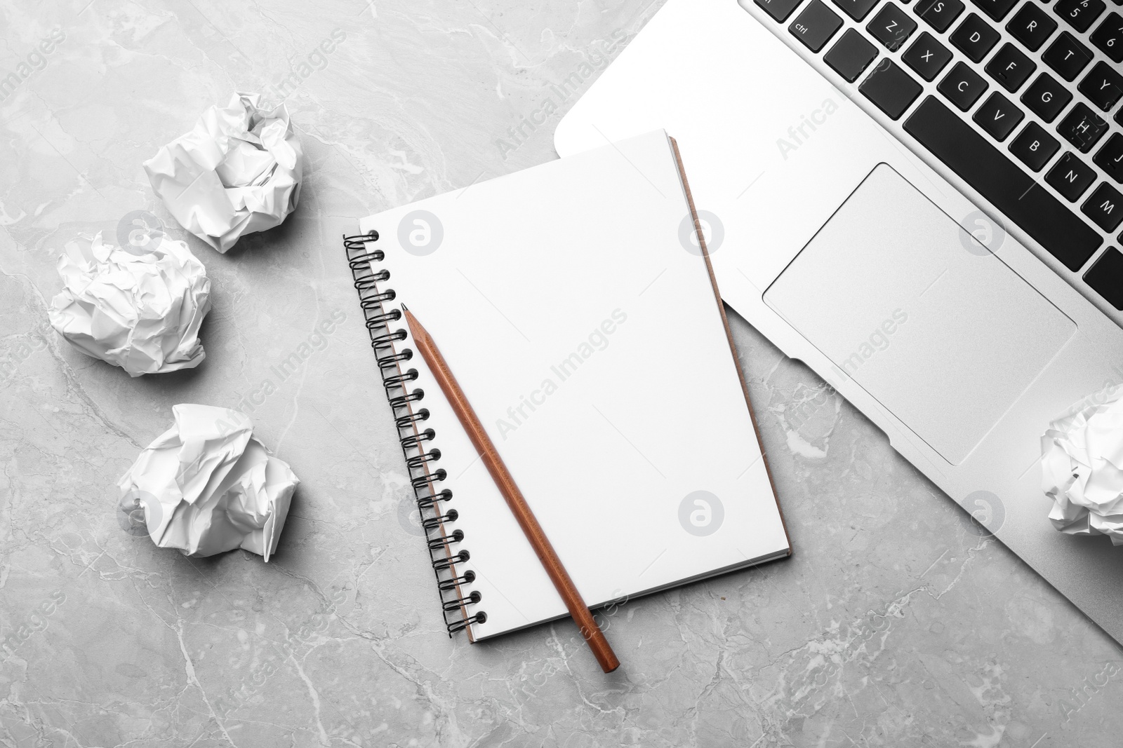 Photo of Flat lay composition with notebook and crumpled paper on grey table. Space for text